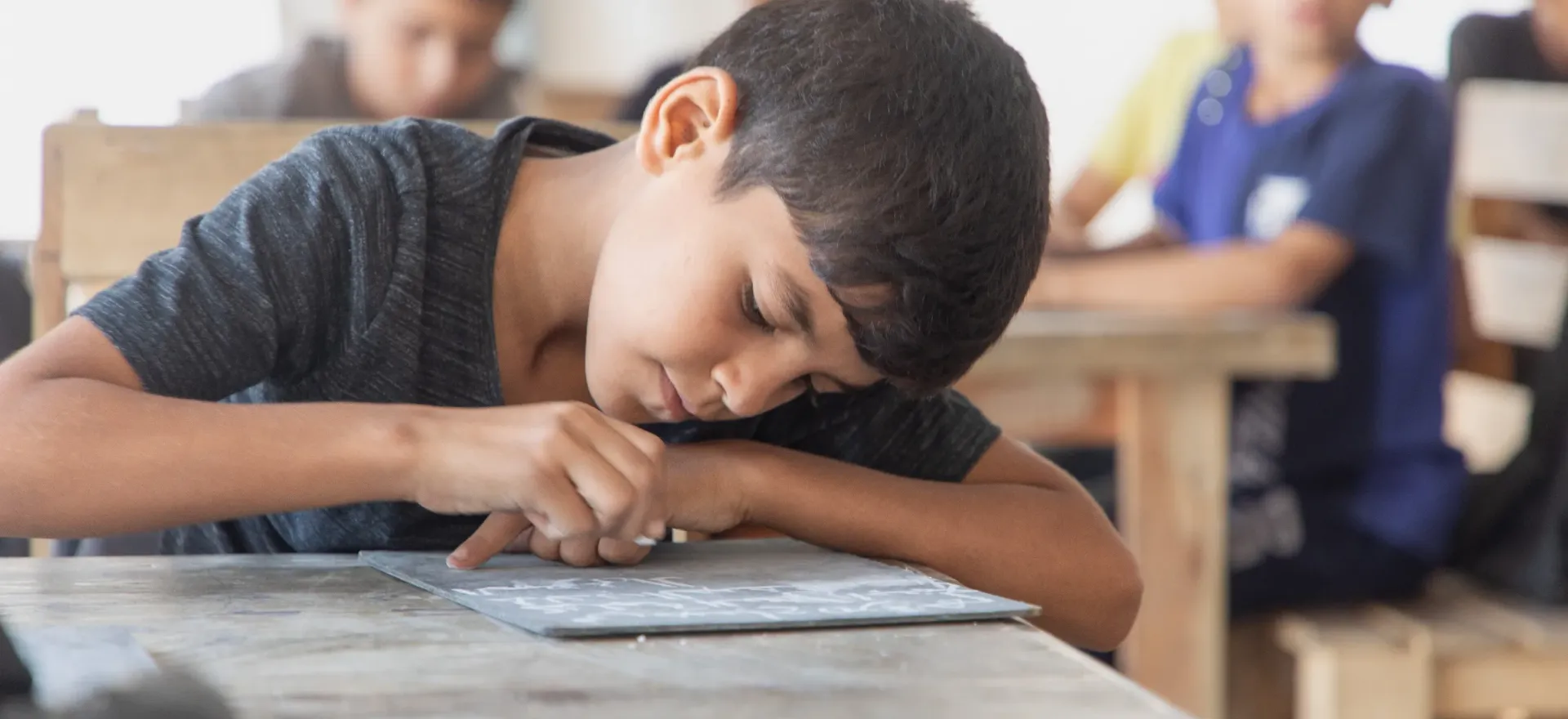 Child writing in a text book