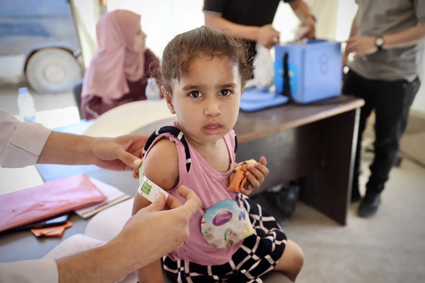A Palestinian girl in the Gaza Strip has her upper arm measured for malnutrition at a UNICEF-supported mobile clinic in Gaza City.