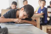 Child writing in a text book