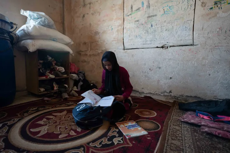 Mathayel, 13, studies at home in Arab Al-Rashayida village in the West Bank. Despite limited space, economic hardship and repeated violence, Mathayel remains committed to her education.
