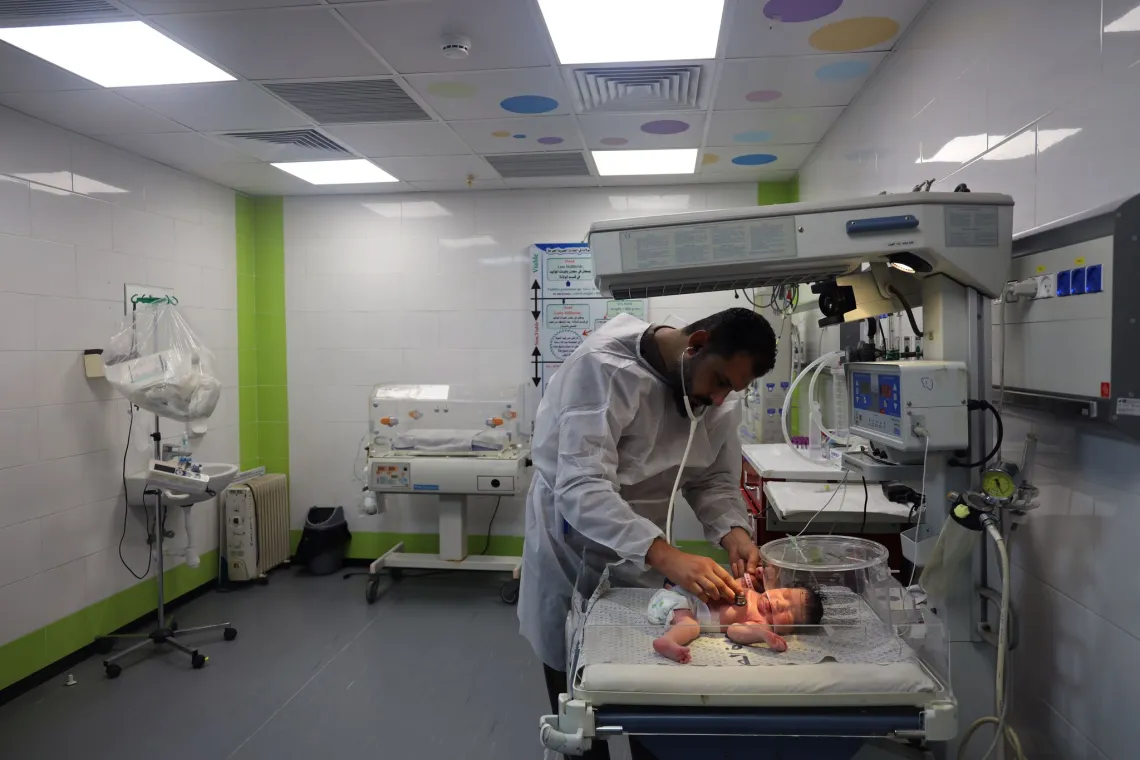 Dr. Mohammed checks the health of a newborn baby in the AL-Emirati hospital. 