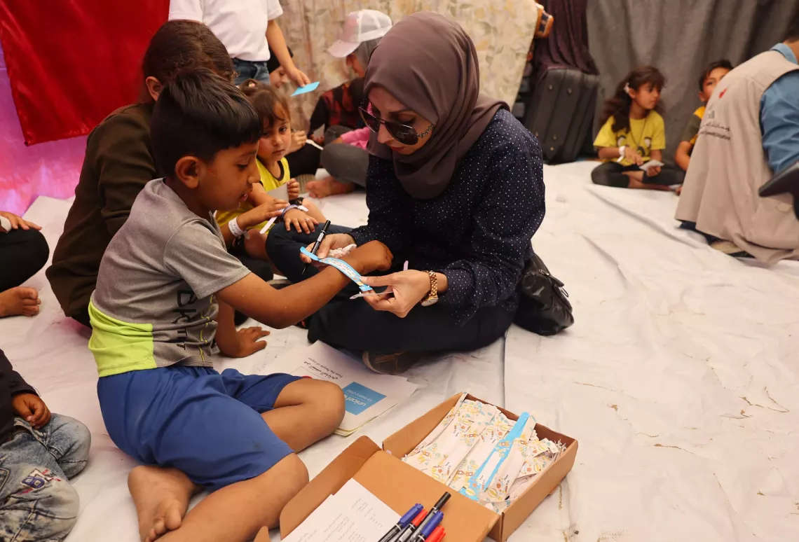 A young boy receives an identity bracelet in Rafah, southern Gaza Strip.