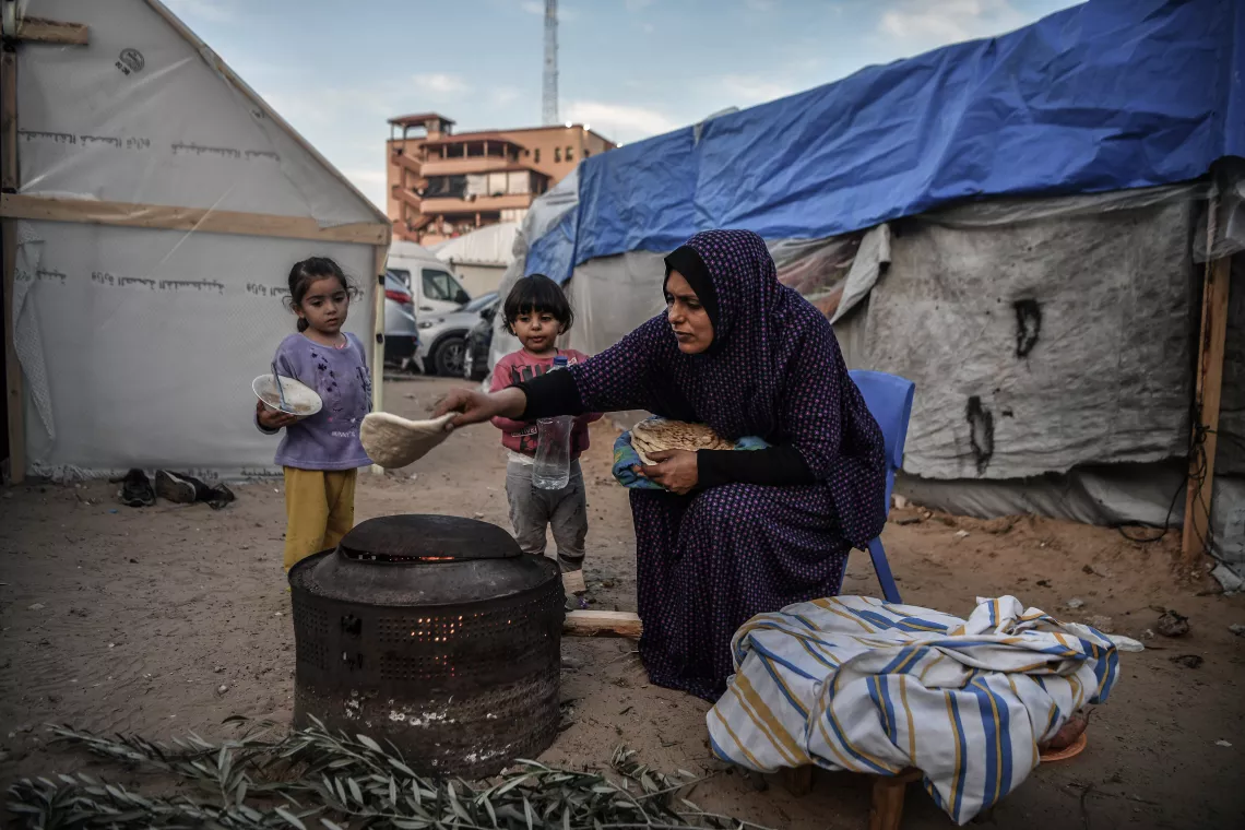 Seba baking bread for her children.