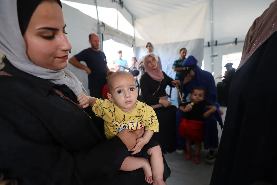 Wafaa Al-Joujou is at the Gaza City clinic with her six-month-old son, Jamal, for a nutrition screening. It was her second visit to the mobile clinic; she was encouraged to return because the clinic was close and the services were beneficial.