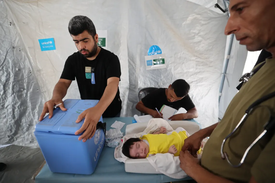 Doctor Hassan Ayad examines infant, Lia, at a UNICEF-supported mobile clinic in Gaza City. He says they&rsquo;ve seen a reduction in malnutrition cases over time.