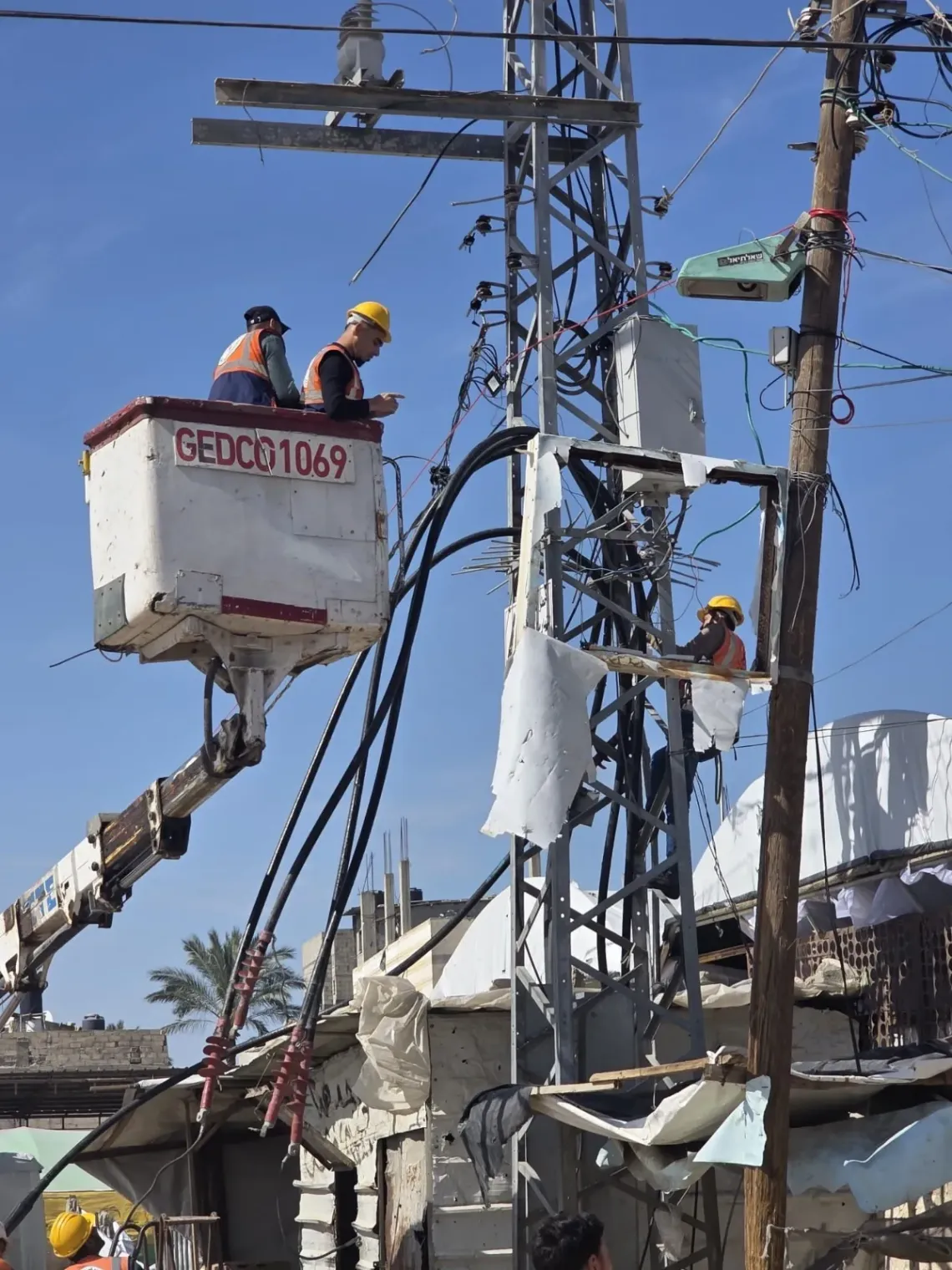 Workers repair a damaged powerline in southern Gaza.