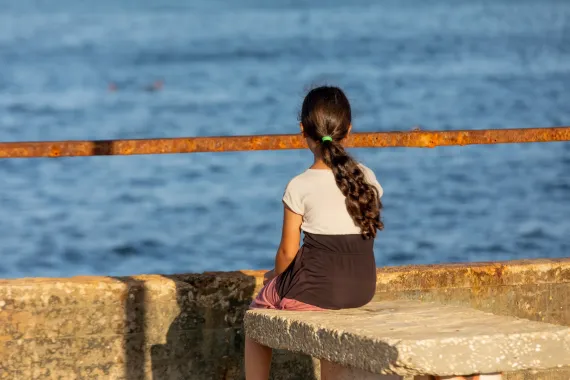 Amal sitting near the sea