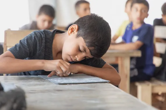 Child writing in a text book