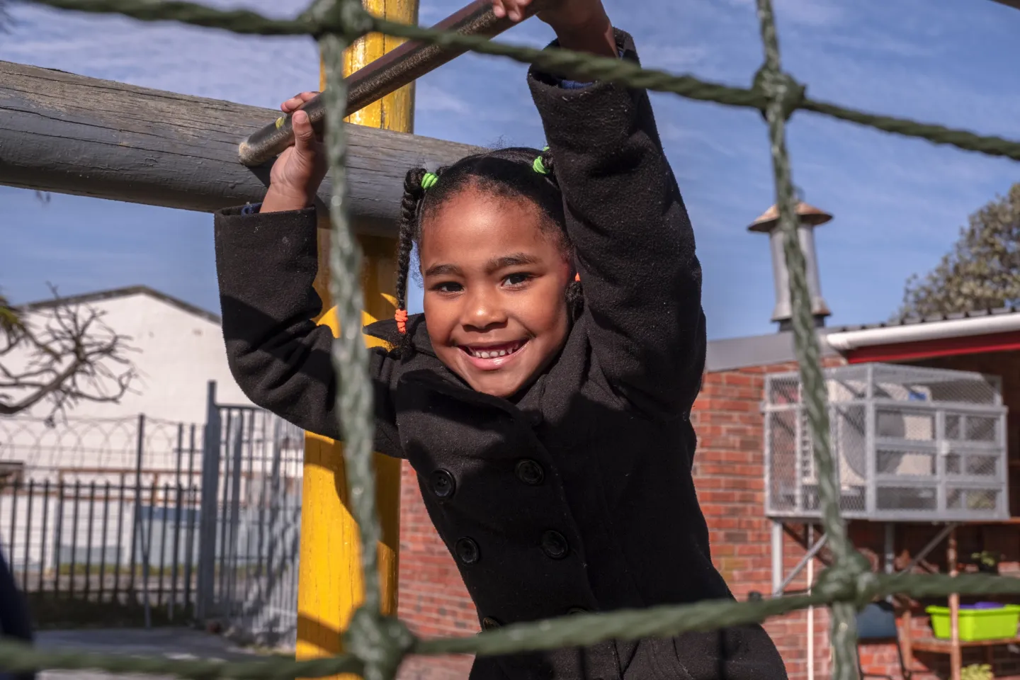 A young girl plays on a jungle gym, while taking part in the International Day of Play.