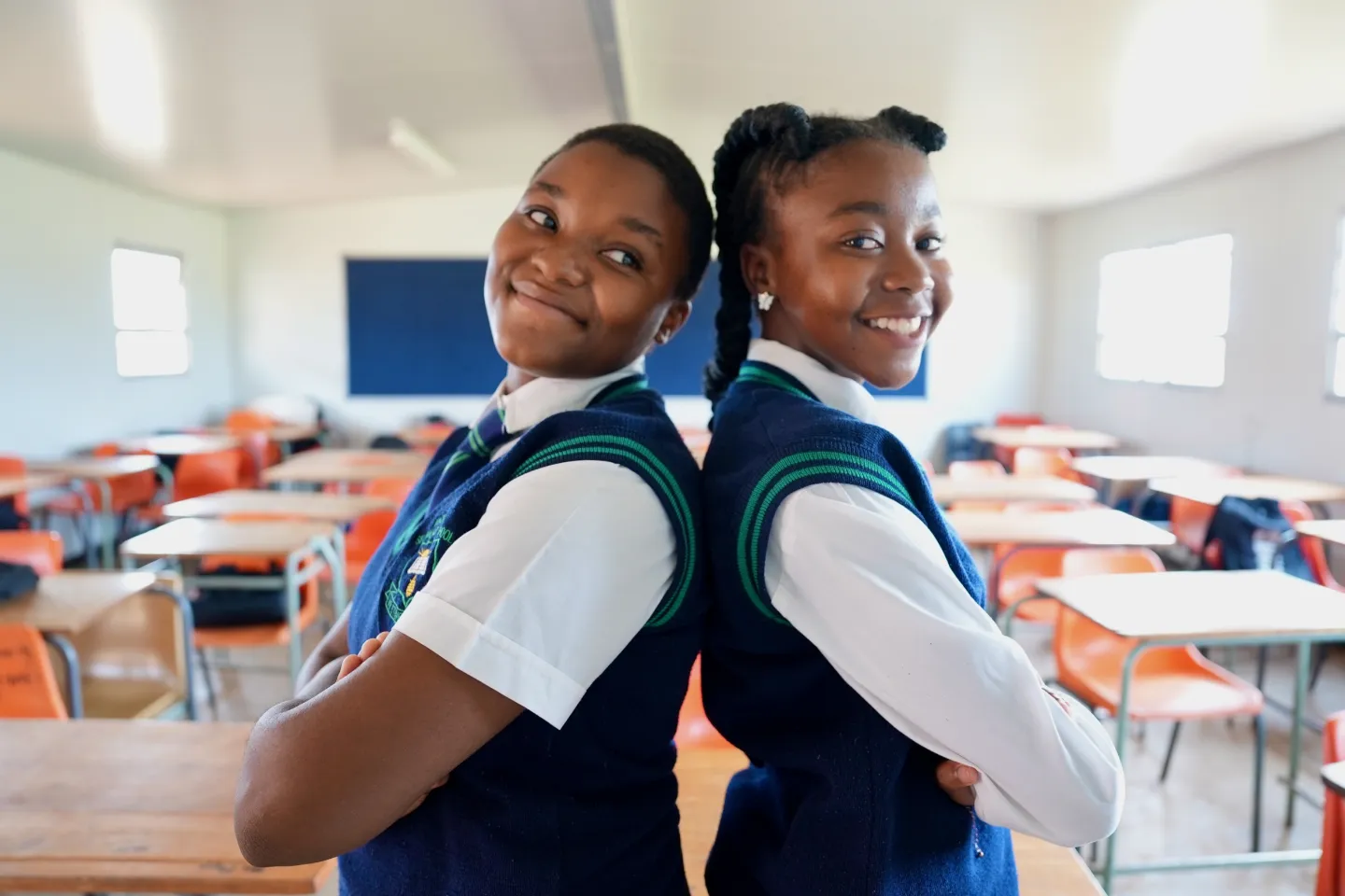 Khensani Hlophe (left) and Lesedi Molefe (right) stand inside their classroom at Kgokare Secondary School in Sebokeng, Gauteng province.