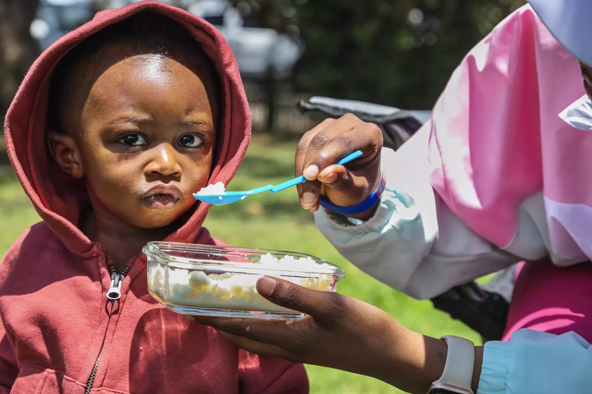 A small child is being fed by spoon
