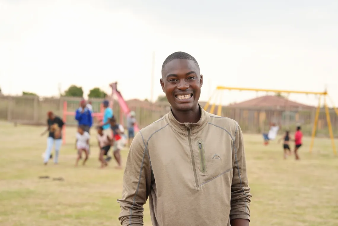 A young man smiles for a photo
