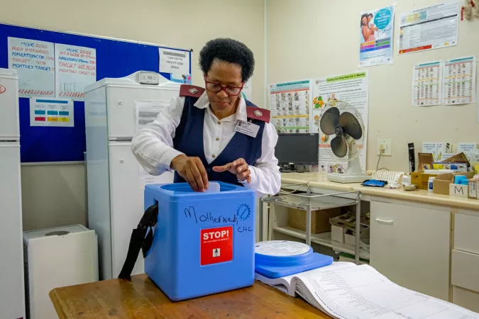 nurse packing cold storage box for vaccine transportation