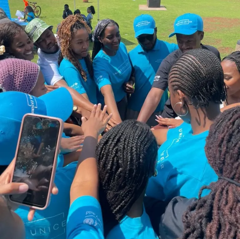 A group of young people wearing blue UNICEF Volunteer t-shirts.