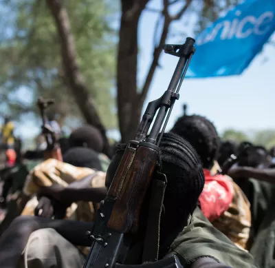 A child soldier and his gun