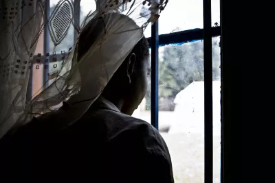 A former child soldier gazing out a window