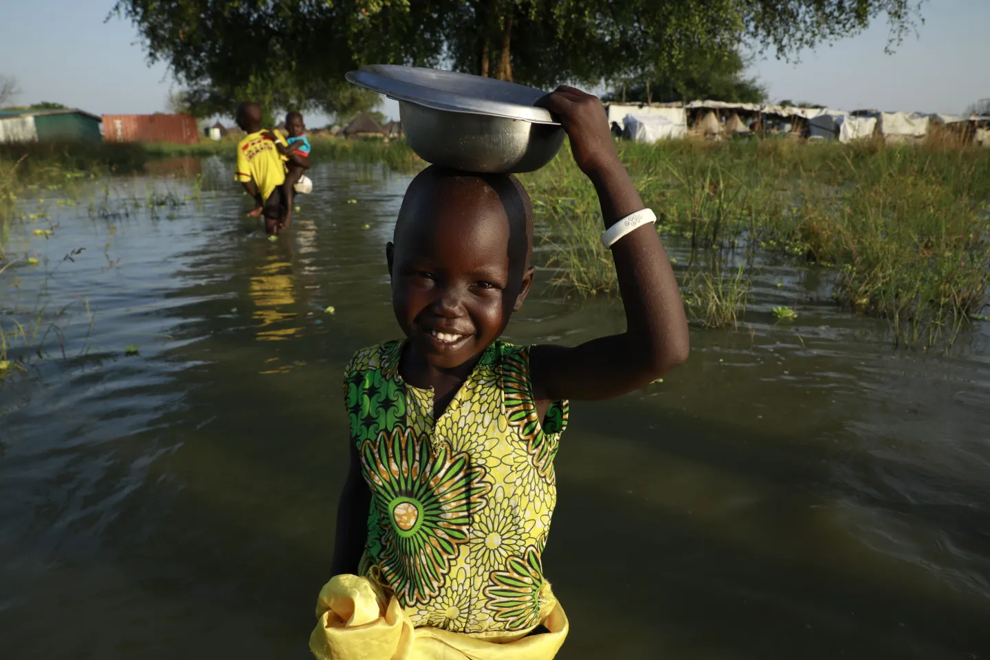 Child walking through floodwaters. 