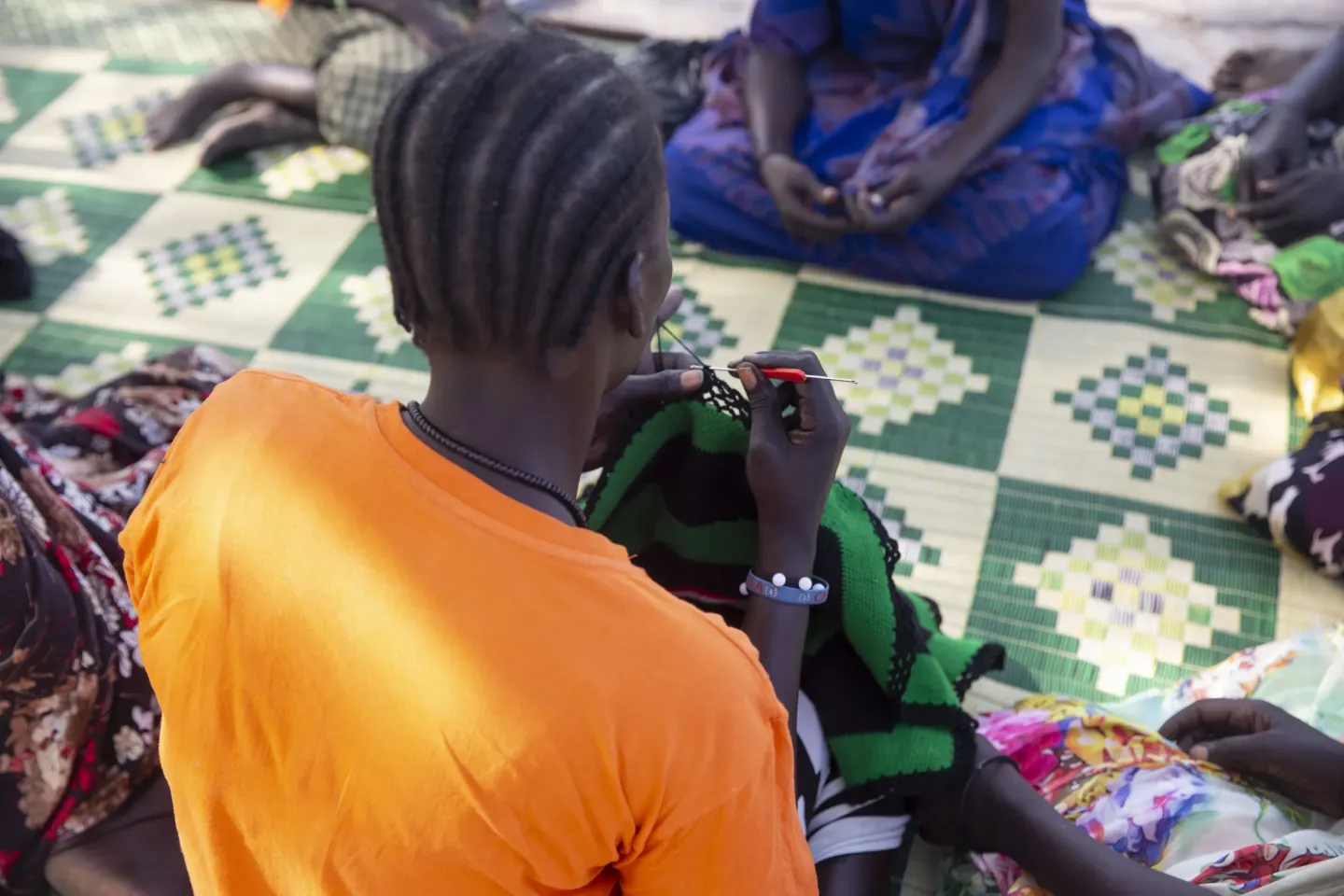 a women is making an embroidery in a women and girl friendly space in Bentiu