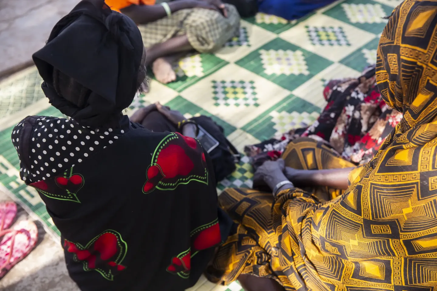 women are sitting at a women and girls friendly space in South Sudan