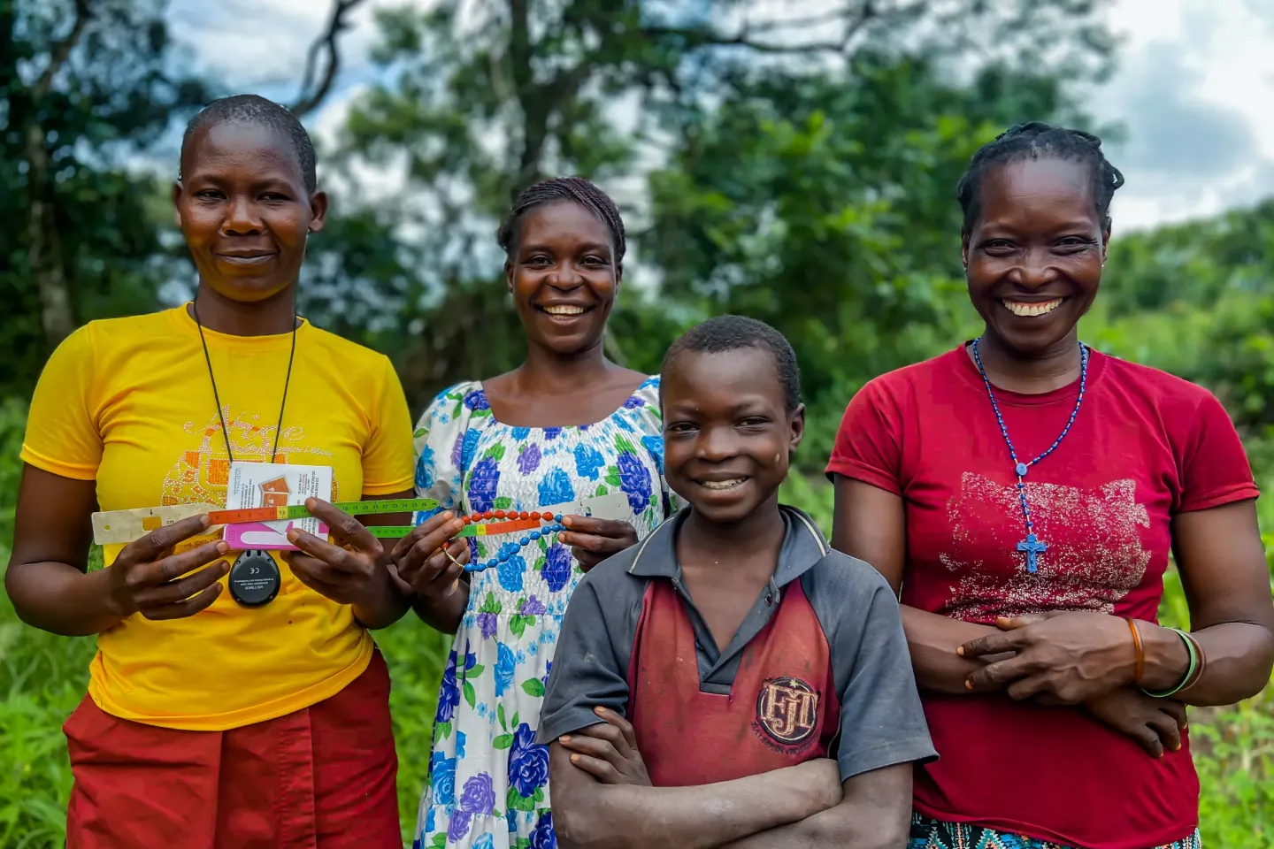 A Boma health worker is photographed with a family in Yambio with whom she shares health information