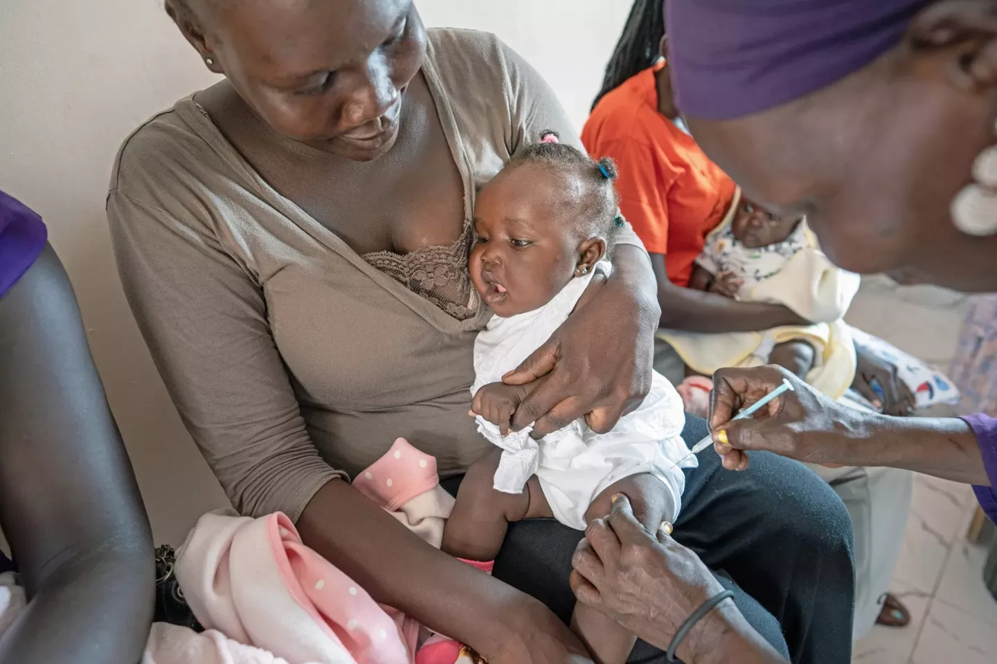 a nurse is vaccinating a baby at a Health center supported by UNICEF