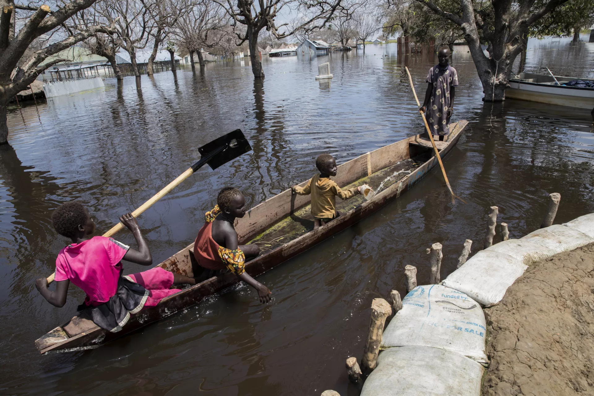 Children in a canoe rowing towards a dyke from nearby island at Pawuel village of Twic East state of Jonglei state on October 23, 2021 in South Sudan. 