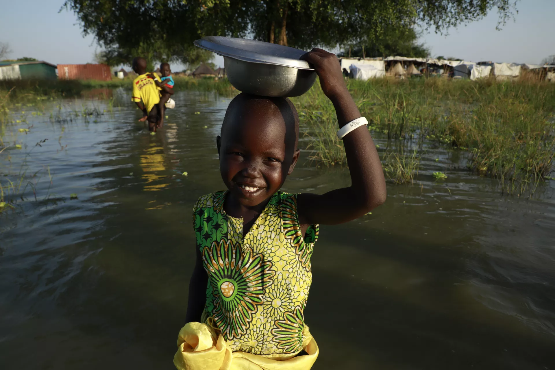 Child walking through floodwaters. 