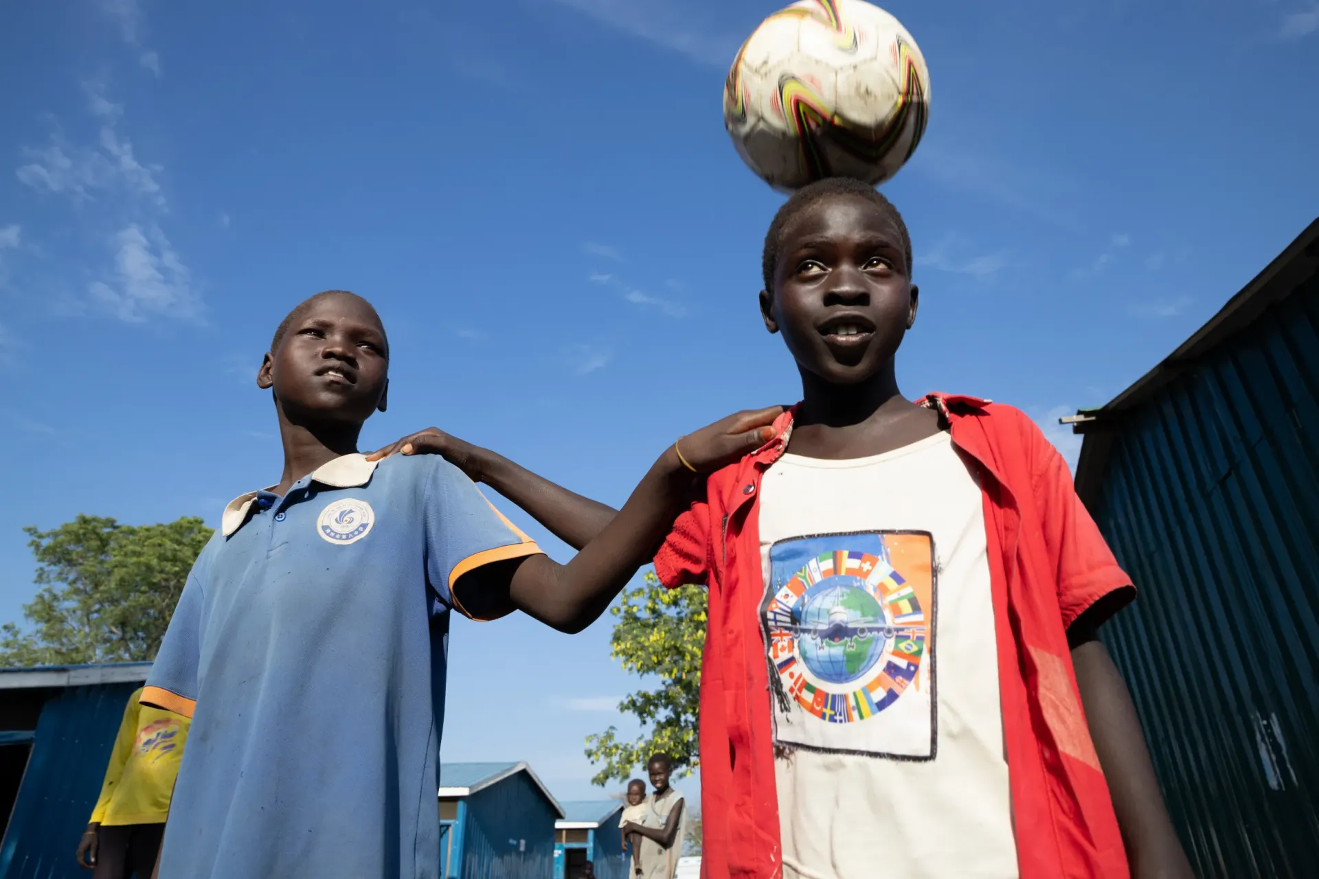 Joseph and Aweng are playing at Bulukat Transit Center in Malakal
