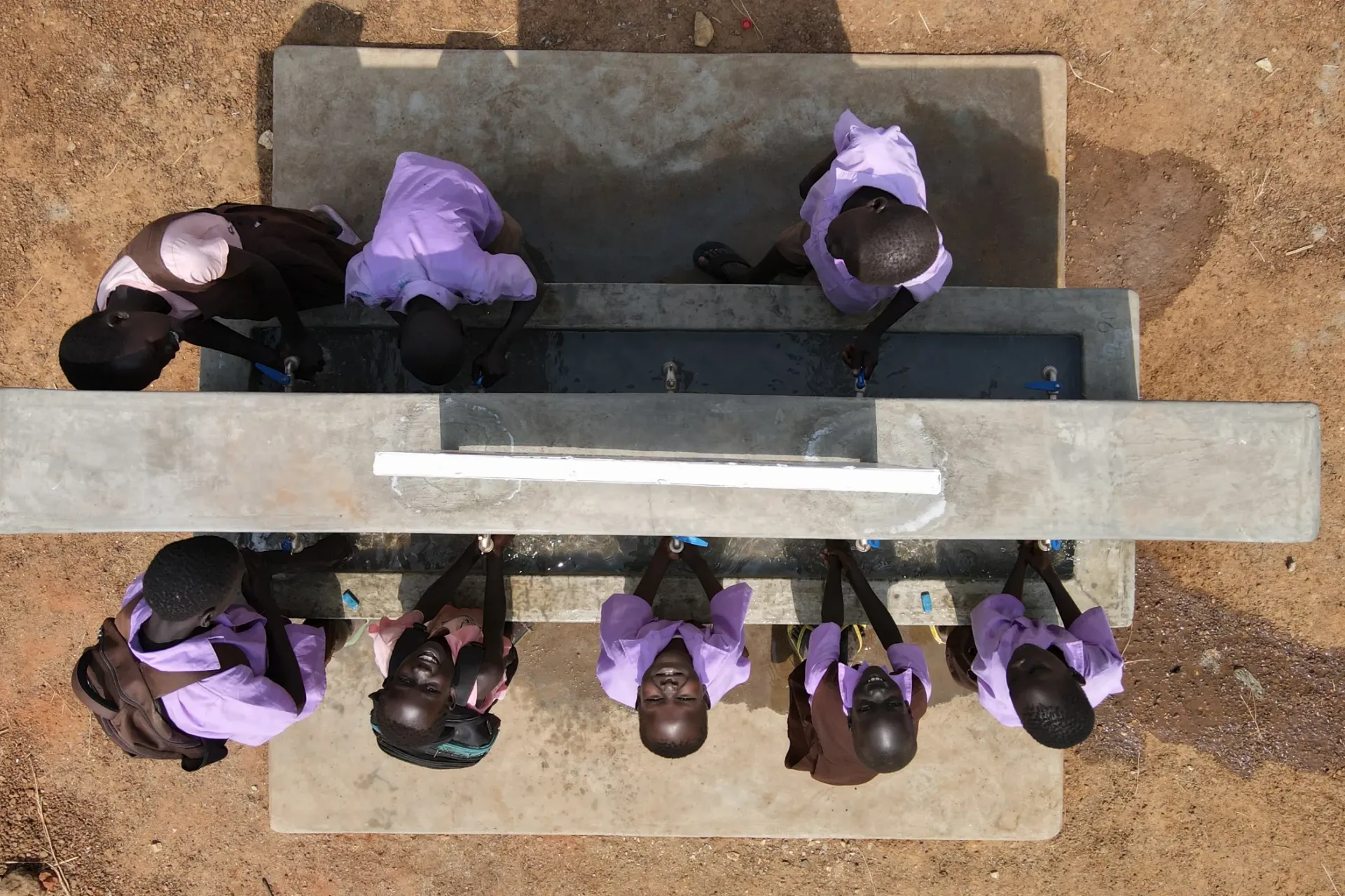 Children are washing their hands in school.