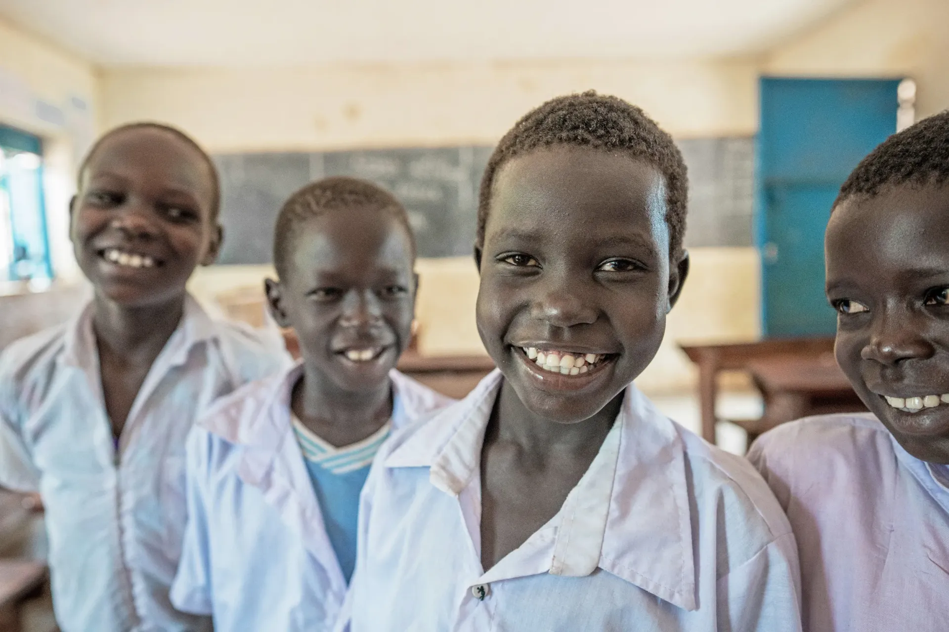 children are photographed in the classroom smiling at Oyere Primary School, South Sudan