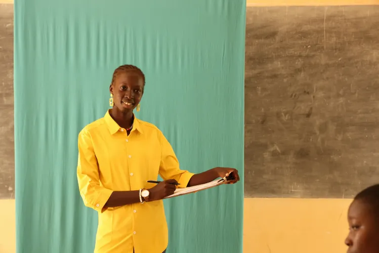 young girl in a classroom in front of students