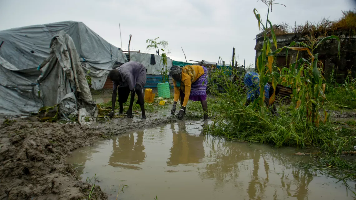 Handmade mud dykes, repaired daily, are the only defense against the quickly rising flood waters.