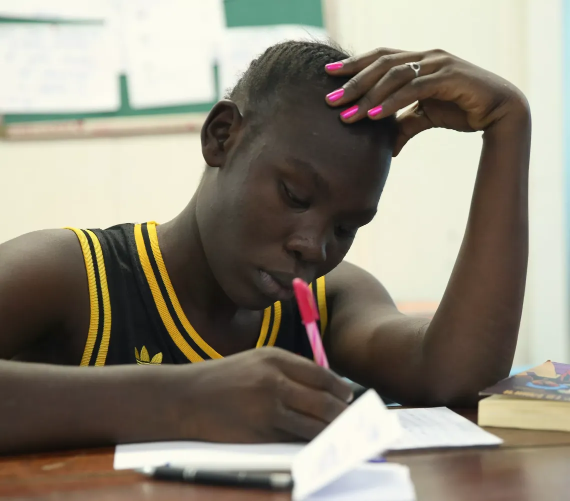 Yomima a UNICEF young reporter is writing a letter to participate in the international letter writing competition