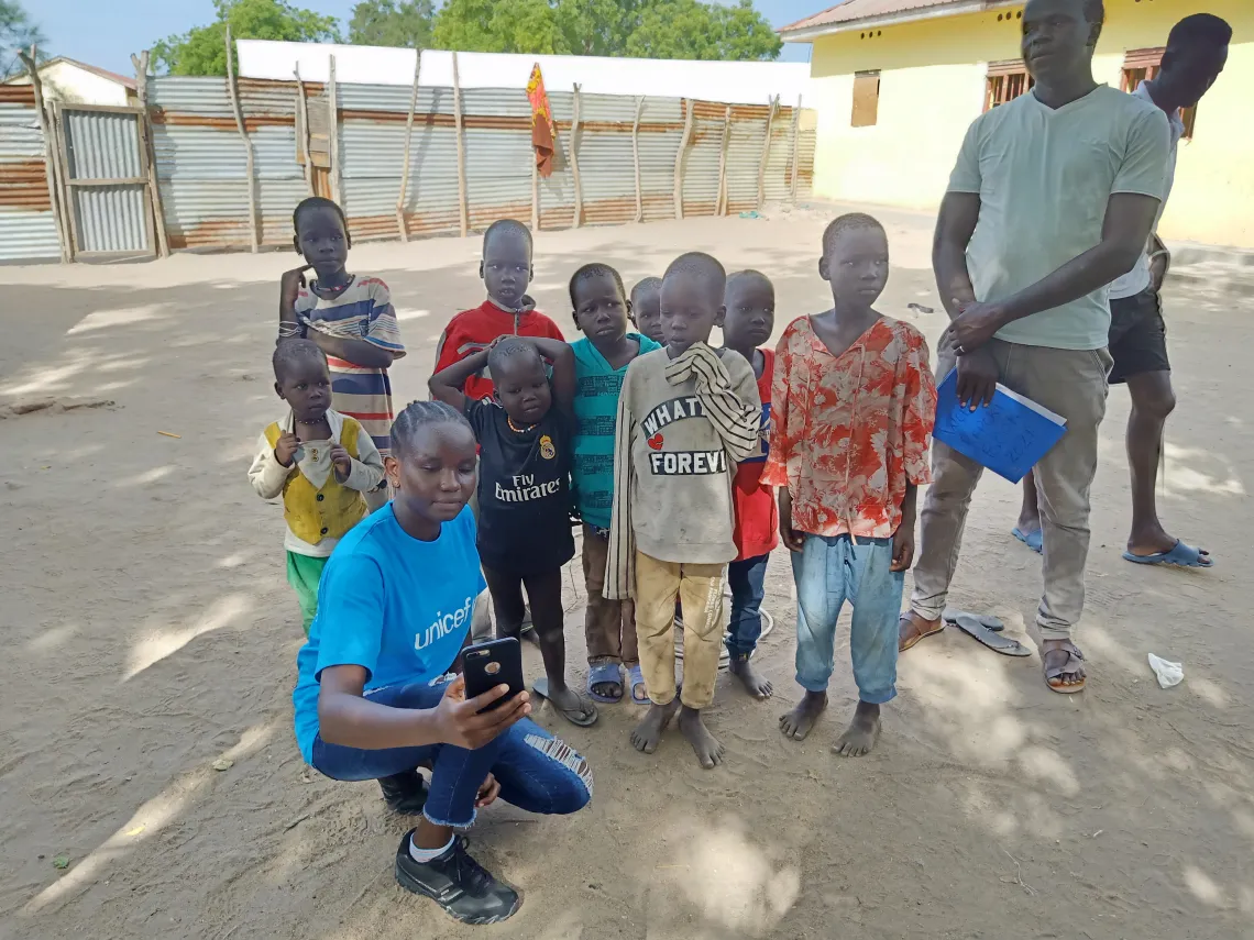 Christine poses for a selfie with young children