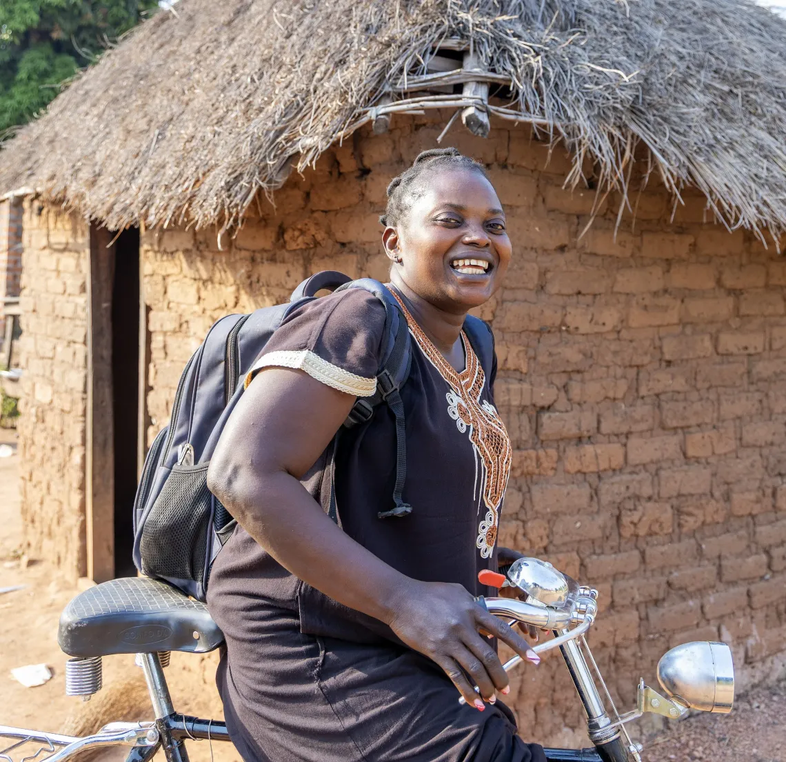 Alice is on her bicycle as she is being photographed in Yambio South Sudan