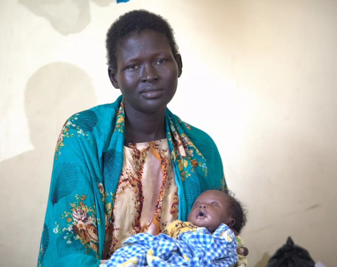 Lith is photographed at a hospital holding her baby.