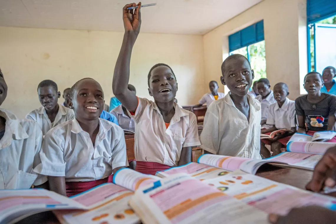Children in the classroom are photographed as they interact during the lesson.