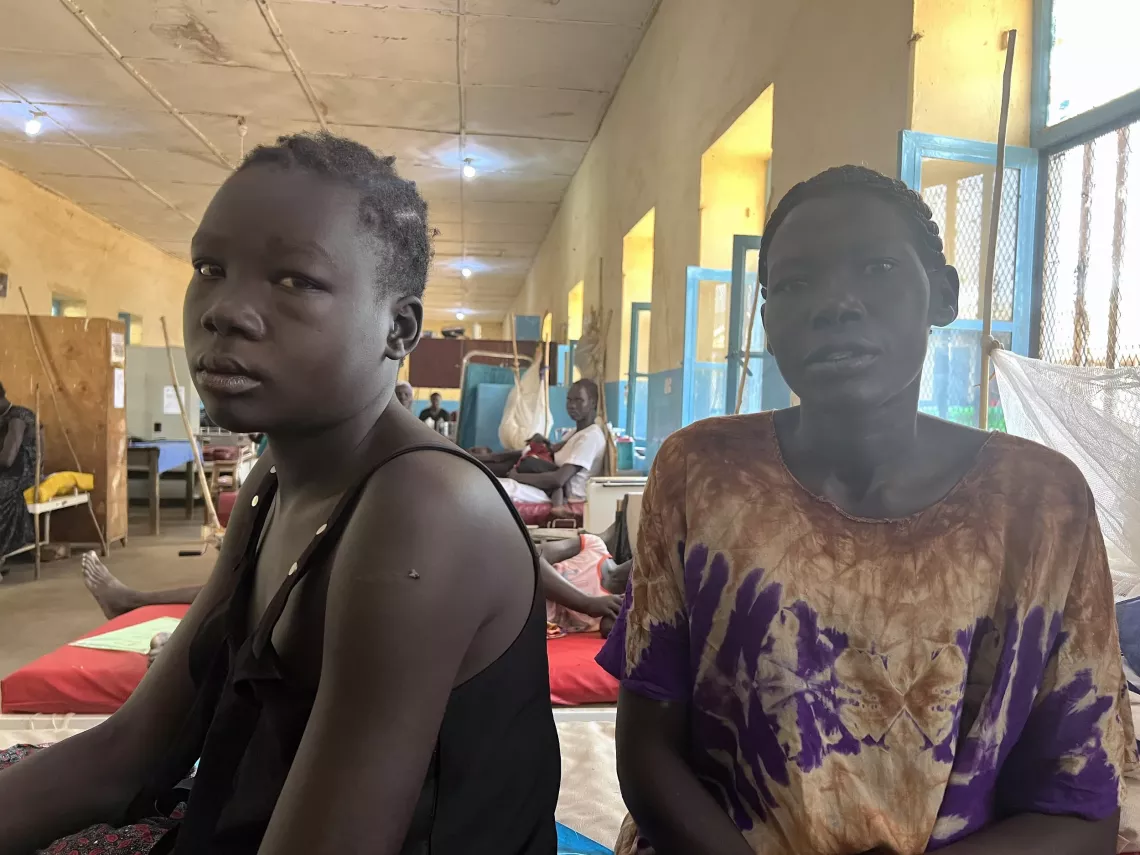 Rose Adhel Yel, a mother of seven, sits by her 14-year-old daughter Ayuen Malong. 