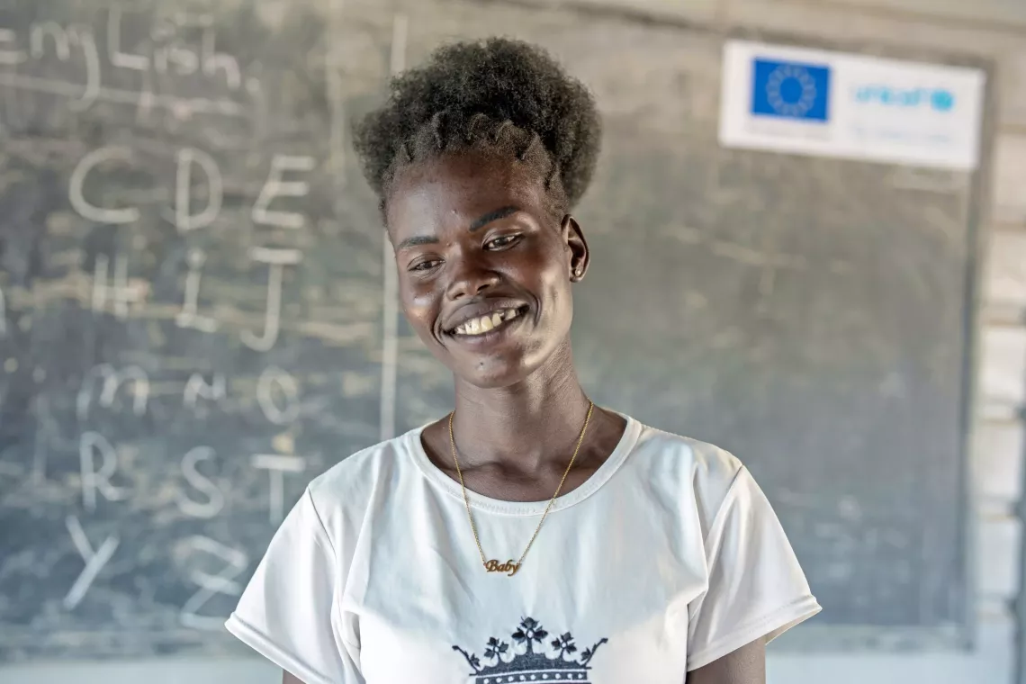A female teacher stands in a classroom in South Sudan