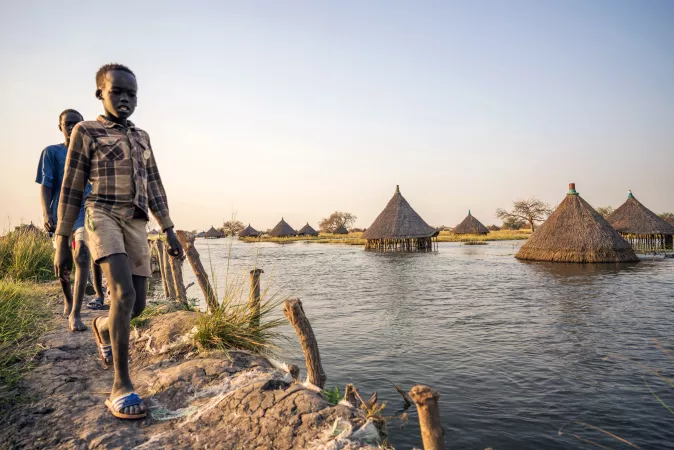 children walking along flooded area in Bentiu, South Sudan
