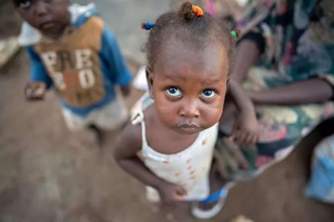 A little child is photographed in Renk looking up