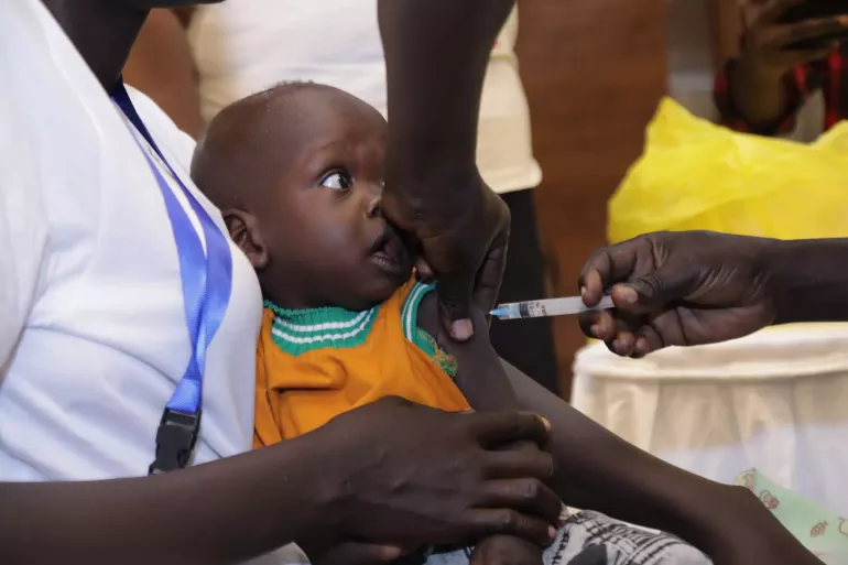 Child is photographed as he is receiving malaria vaccine