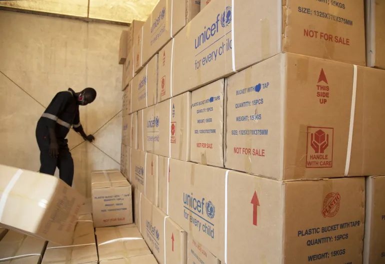 A man lifting boxes in a warehouse