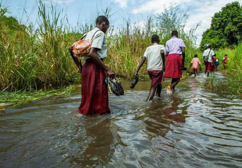 Student trying to reach their school through flooded area, walangwalang, Juba, South Sudan