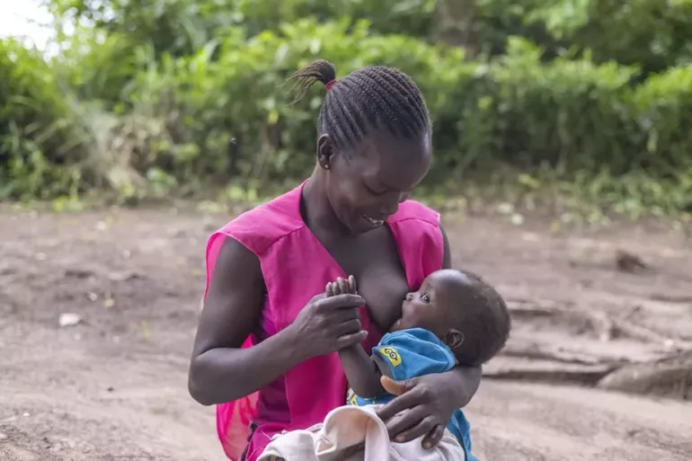 Rahama is breastfeeding her baby in Yambio, South Sudan