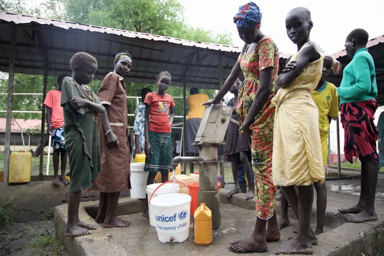 Community members fetch water at a borehole at Akobo Hospital