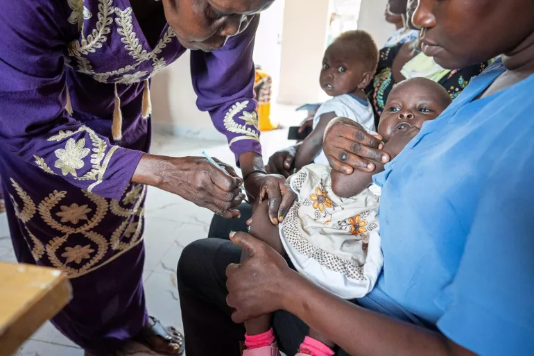 On the 24th July 2024, Peresi Justin&nbsp;vaccinates a child in the UNICEF-supported immunisation clinic at Kimu Primary Healthcare Centre in Juba, South Sudan. According to Peresi, "nothing gives me greater pleasure than preventing the spread of deadly diseases. &nbsp;By vaccinating children, we are saving not just the children themselves but their families and entire communities".
