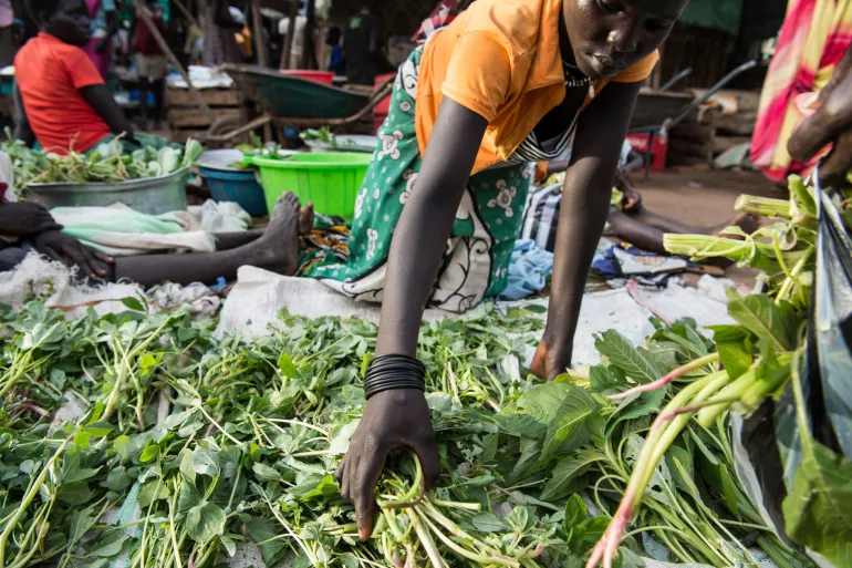 In South Sudan, women sell wild greens at a market.