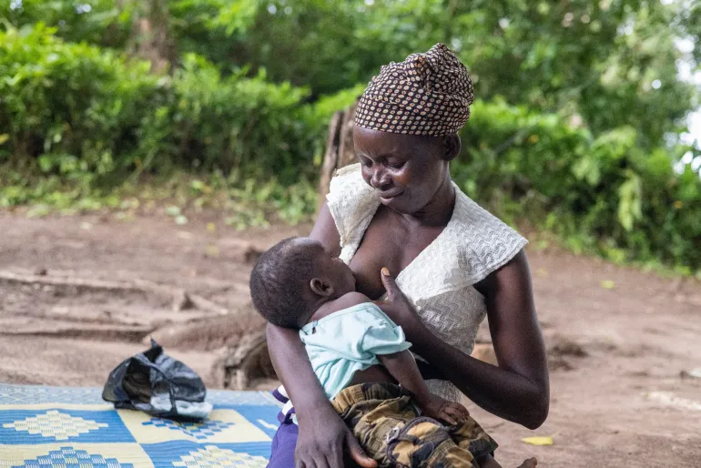 A mother breastfeeds her child in Yambio
