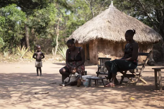 A village setting where women are plating hair